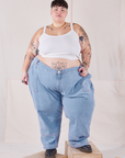 Jordan is wearing Petite Carpenter Jeans in Light Wash and vintage off-white Cami