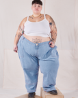 Jordan is wearing Petite Carpenter Jeans in Light Wash and Cropped Cami in vintage tee off-white