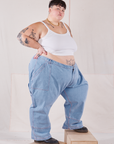 Angled side view of Petite Carpenter Jeans in Light Wash and Cropped Cami in vintage tee off-white on Jordan