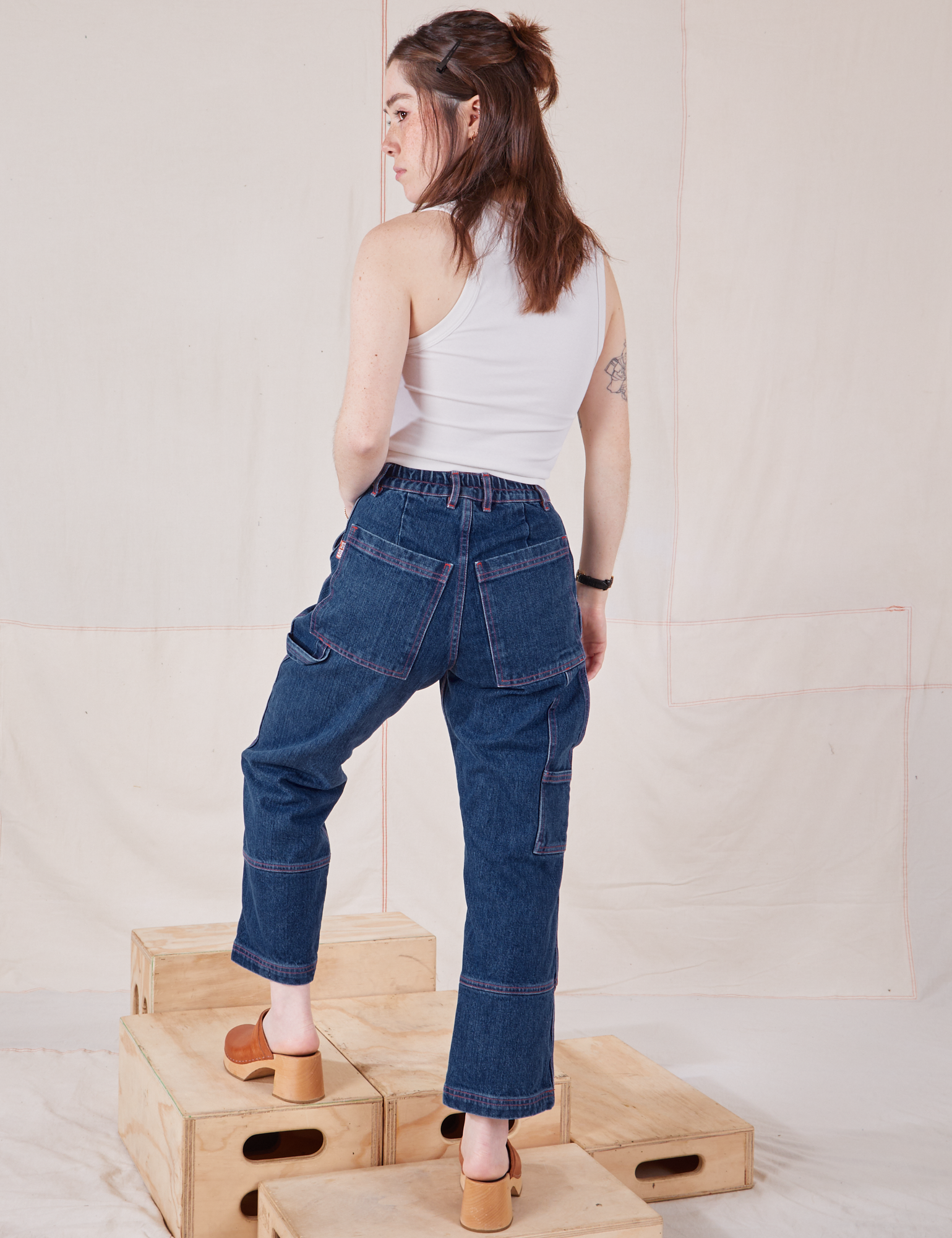 Back view of Petite Carpenter Jeans in Dark Wash and Tank Top in vintage tee off-white on Hana