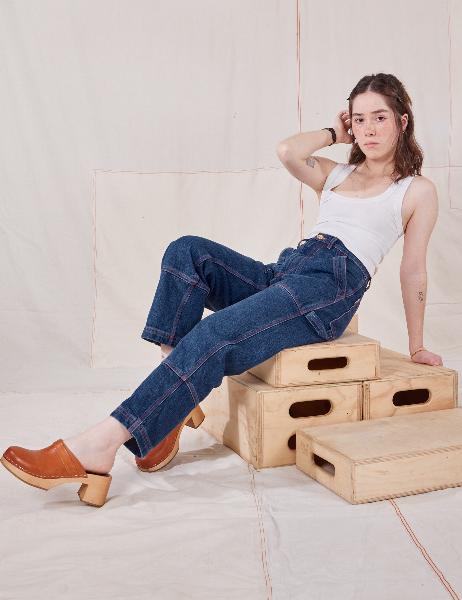 Hana is wearing Petite Carpenter Jeans in Dark Wash and Cropped Tank Top in vintage tee off-white