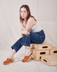 Hana is wearing Petite Carpenter Jeans in Dark Wash and Cropped Tank Top in vintage tee off-white