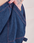 Petite Carpenter Jeans in Dark Wash front pocket close up. Jordan has their hand in the pocket.