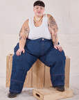 Jordan is wearing Petite Carpenter Jeans in Dark Wash and Tank Top in vintage tee off-white