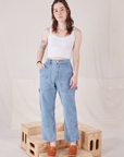 Hana is 5'3" and wearing XXS Petite Carpenter Jeans in Light Wash paired with Cropped Cami in vintage tee off-white 