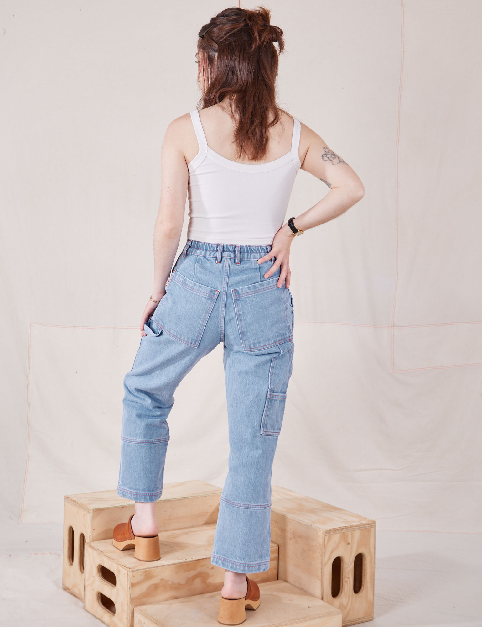 Back view of Petite Carpenter Jeans in Light Wash and Cropped Cami in vintage tee off-white on Hana