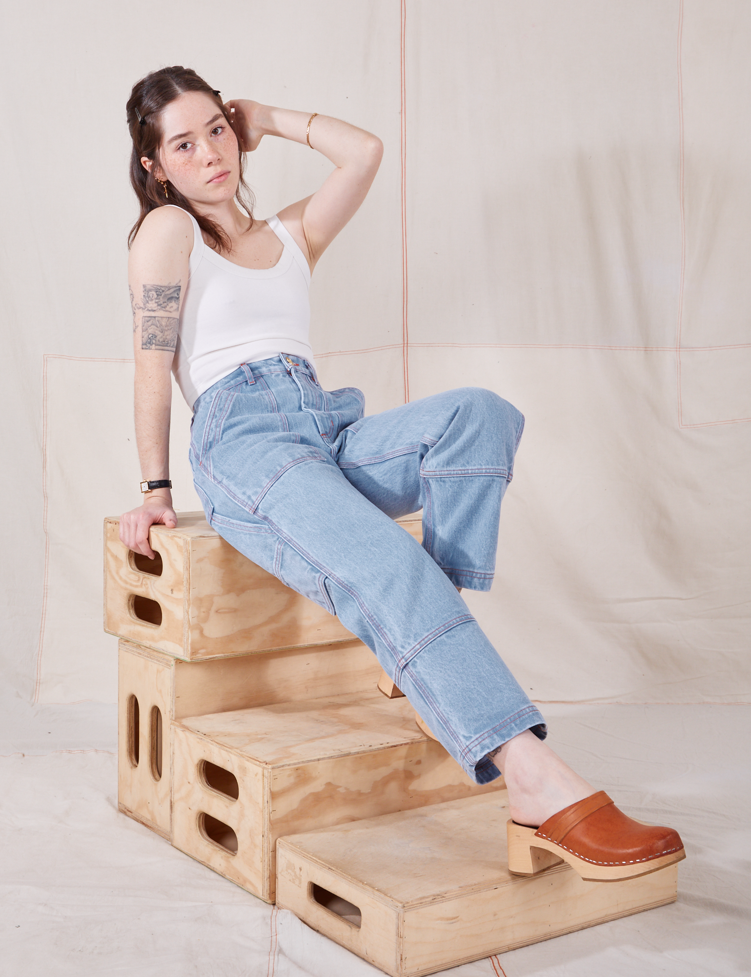 Hana is wearing Petite Carpenter Jeans in Light Wash and Cropped Cami in vintage tee off-white