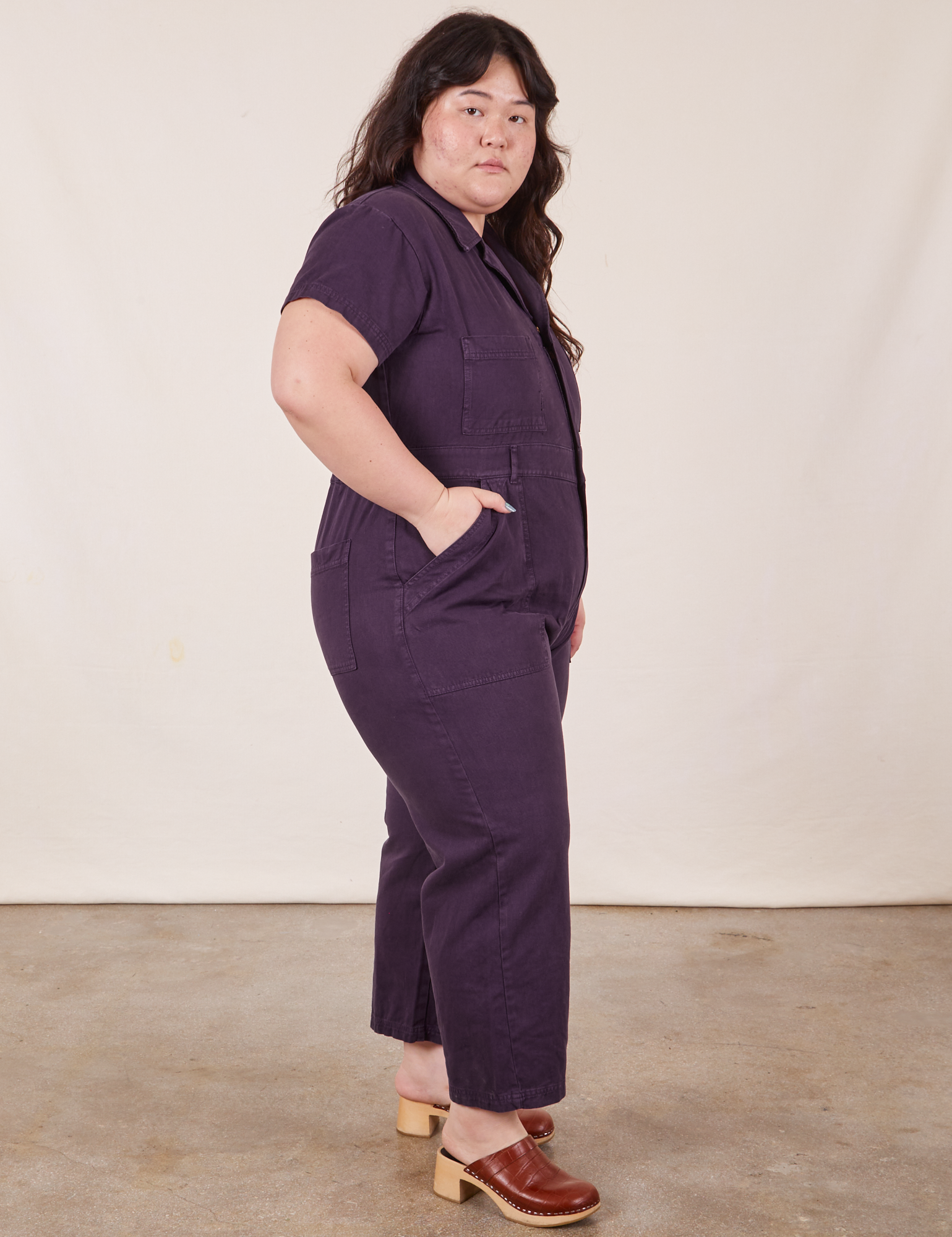 Side view of Petite Short Sleeve Jumpsuit in Nebula Purple worn by Ashley