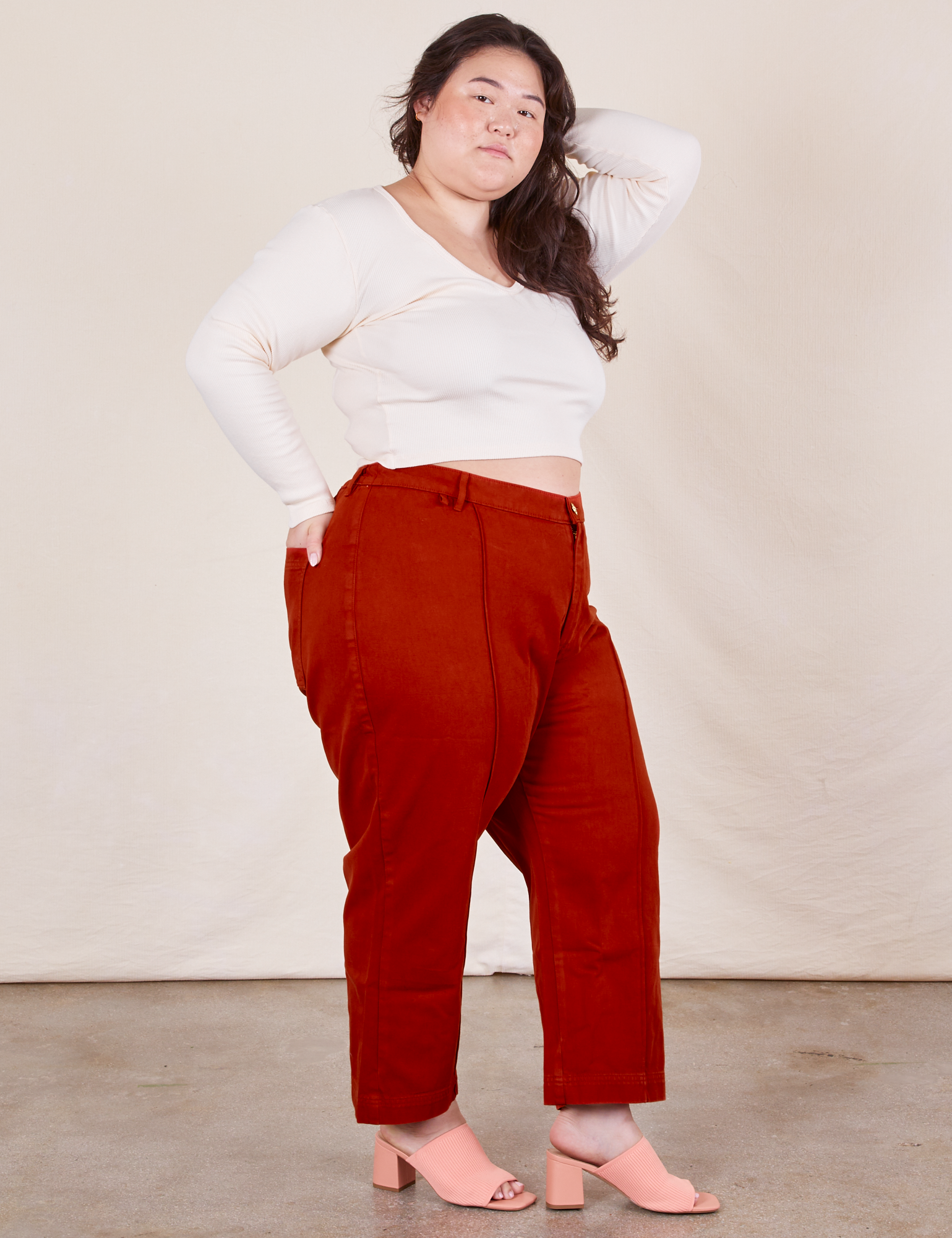 Side view of Western Pants in Paprika paired with a Long Sleeve V-Neck Teein vintage off-white worn on Ashley