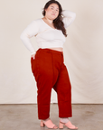 Side view of Western Pants in Paprika paired with a Long Sleeve V-Neck Teein vintage off-white worn on Ashley