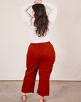Back view of Western Pants in Paprika paired with a Long Sleeve V-Neck Tee in vintage tee off-white worn by Ashley
