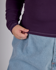 Close up of hem of the Nebula Purple Long Sleeve Porthole Tee worn by Juliet