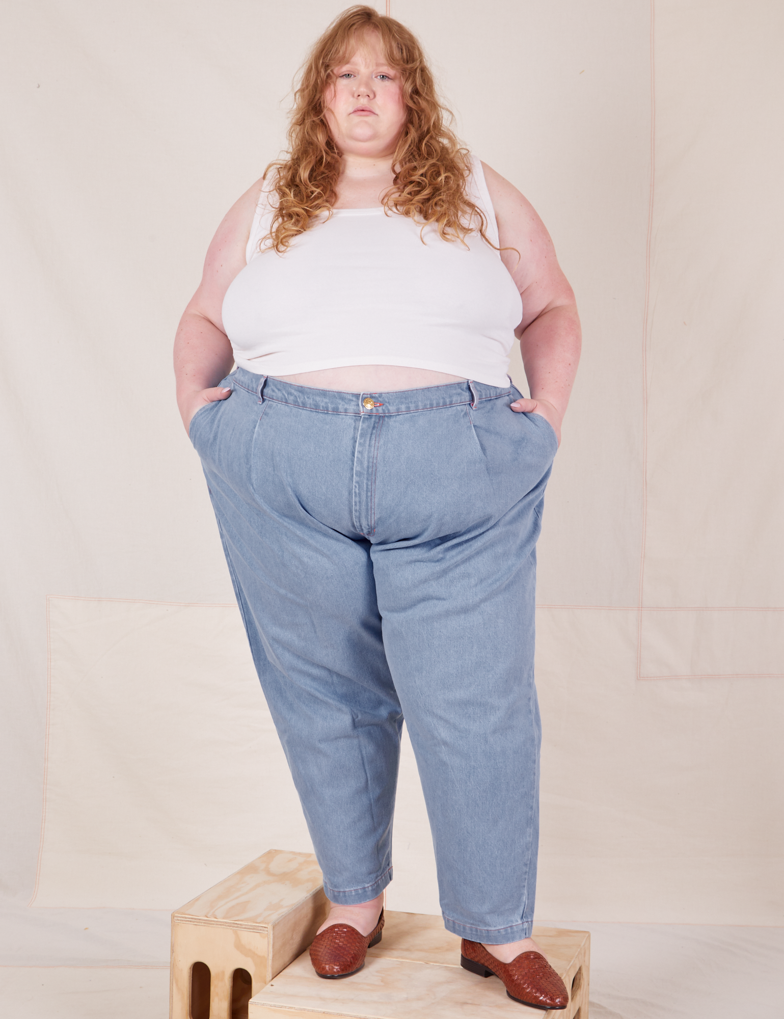 Catie is wearing Denim Trouser Jeans in Light Wash and Cropped Tank Top in vintage tee off-white