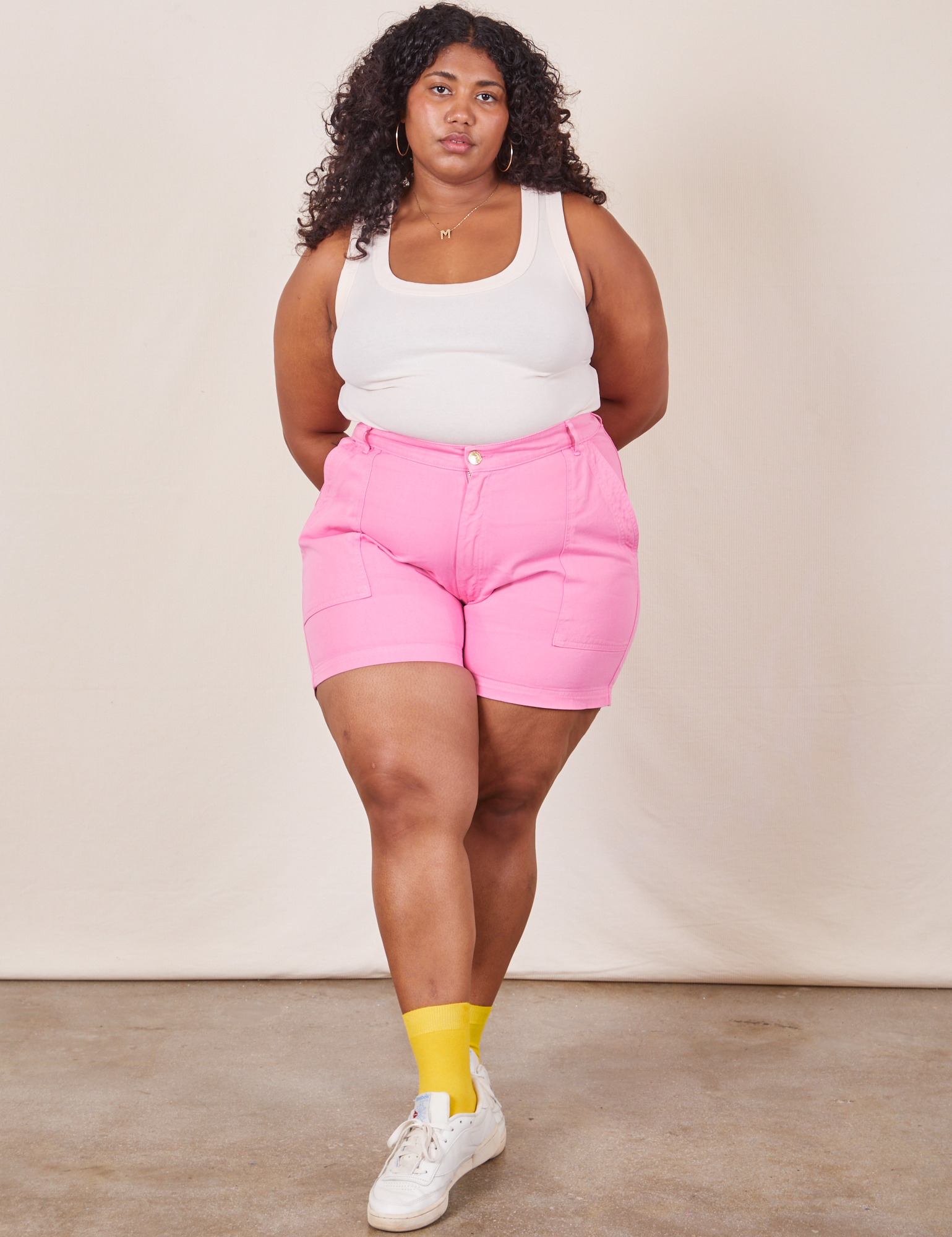 Morgan is wearing Classic Work Shorts in Bubblegum Pink and Tank Top in vintage tee off-white