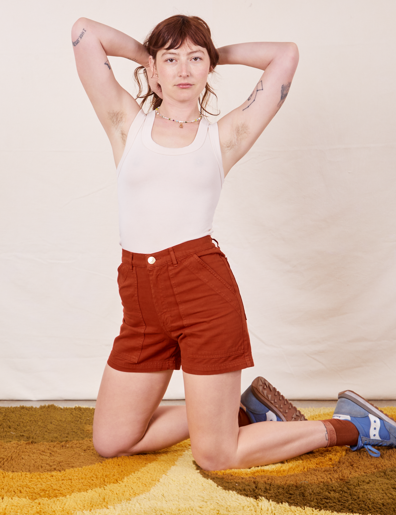 Alex is wearing Classic Work Shorts in Paprika and Tank Top in vintage tee off-white