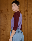 Angled back view of the Faded Grape/Wine Colorblock Raglan Tee on Alex