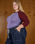Side view of Juliet wearing the Faded Grape/Wine Colorblock Raglan Tee