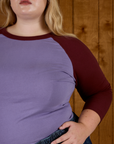 Close up of the Faded Grape/Wine Colorblock Raglan Tee's sleeve on Juliet