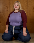Juliet wearing the Faded Grape/Wine Colorblock Raglan Tee tucked into the Dark Wash Denim Drop Pocket Pants