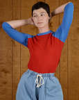 Alex wearing the Mustang Red/Blue Colorblock Raglan Tee tucked into the Light Wash Drop Pocket Pants