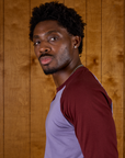 Close up side view of Isaac in the Faded Grape/Wine Colorblock Raglan Tee