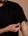 Close up of Burly Tee in Basic Black sleeve on Jesse