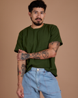 Jesse is 5'8" and wearing S Burly Tee in Evergreen