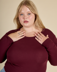 Close up of Juliet in the Red wine Long Sleeve Baby Tee