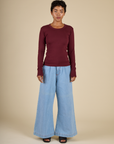 Mika is 5'3" and wearing P Red wine Long Sleeve Baby Tee with Petite Light Wash Denim Wide Leg Trousers