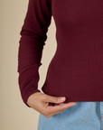 Close up of hem on the Red Wine Long Sleeve Baby Tee work by Tiara