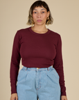Mika wearing the Red wine Long Sleeve Baby Tee tucked in
