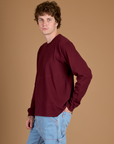 Side view of Quinn wearing the Red Wine Long Sleeve Burly Tee