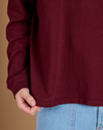 Close up of the Hem on the Red Wine Long Sleeve Burly Tee worn by Quinn