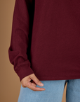 Close up of the hem on the Red Wine Long Sleeve Burly Tee worn by Tiara