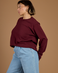 Side view of Tiara wearing the Red Wine Long Sleeve Burly Tee