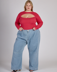 Juliet wearing the Hot Pink Long Sleeve Porthole Tee tucked into Light Wash Denim Wide Leg Trousers