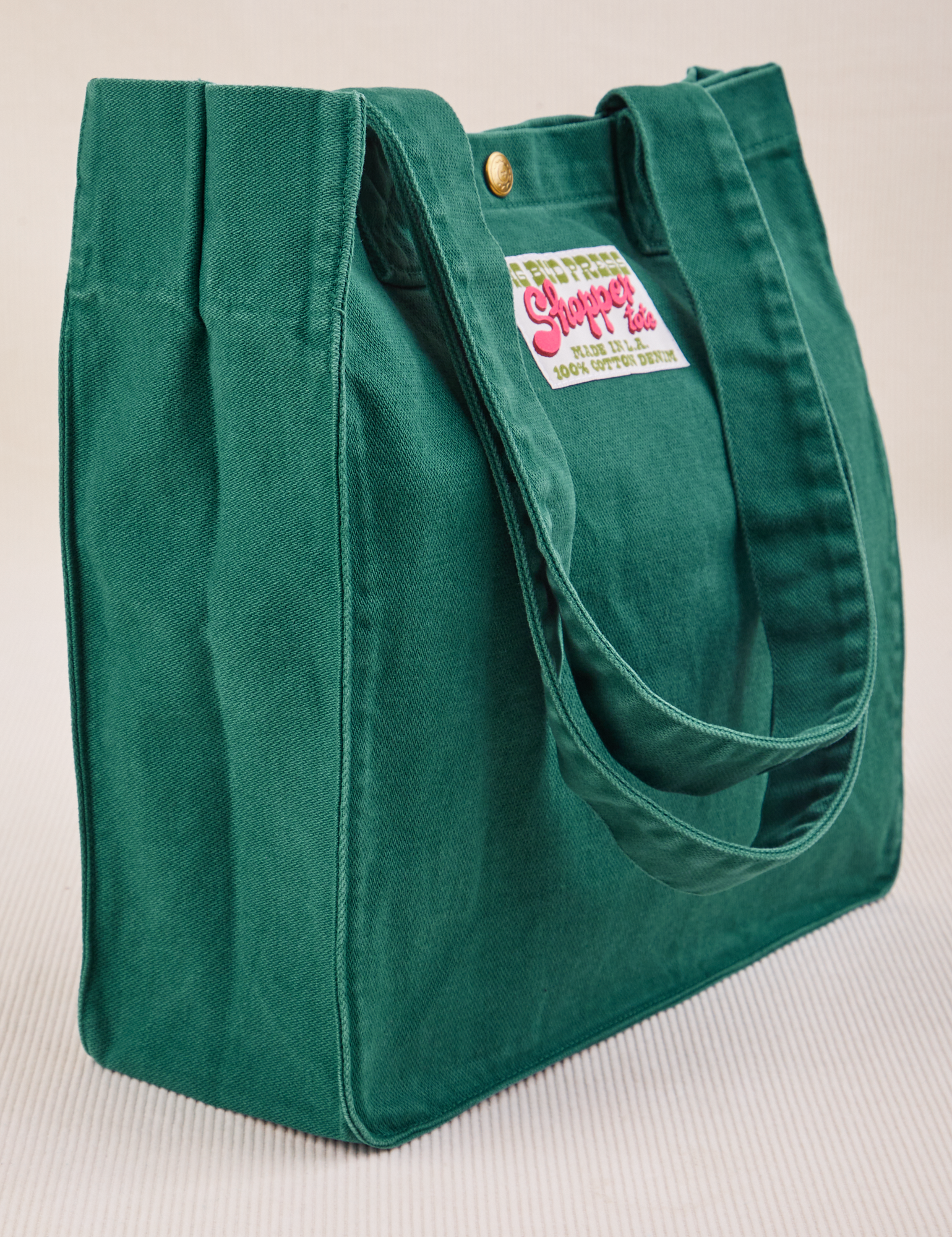 Angled view of Shopper Tote Bag in Hunter Green