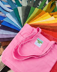 Stacked pile of Everyday Tote in a rainbow of hues