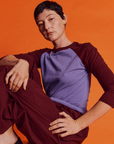 Alex is 5'8" and wearing P Faded Grape/Wine Colorblock Raglan Tee