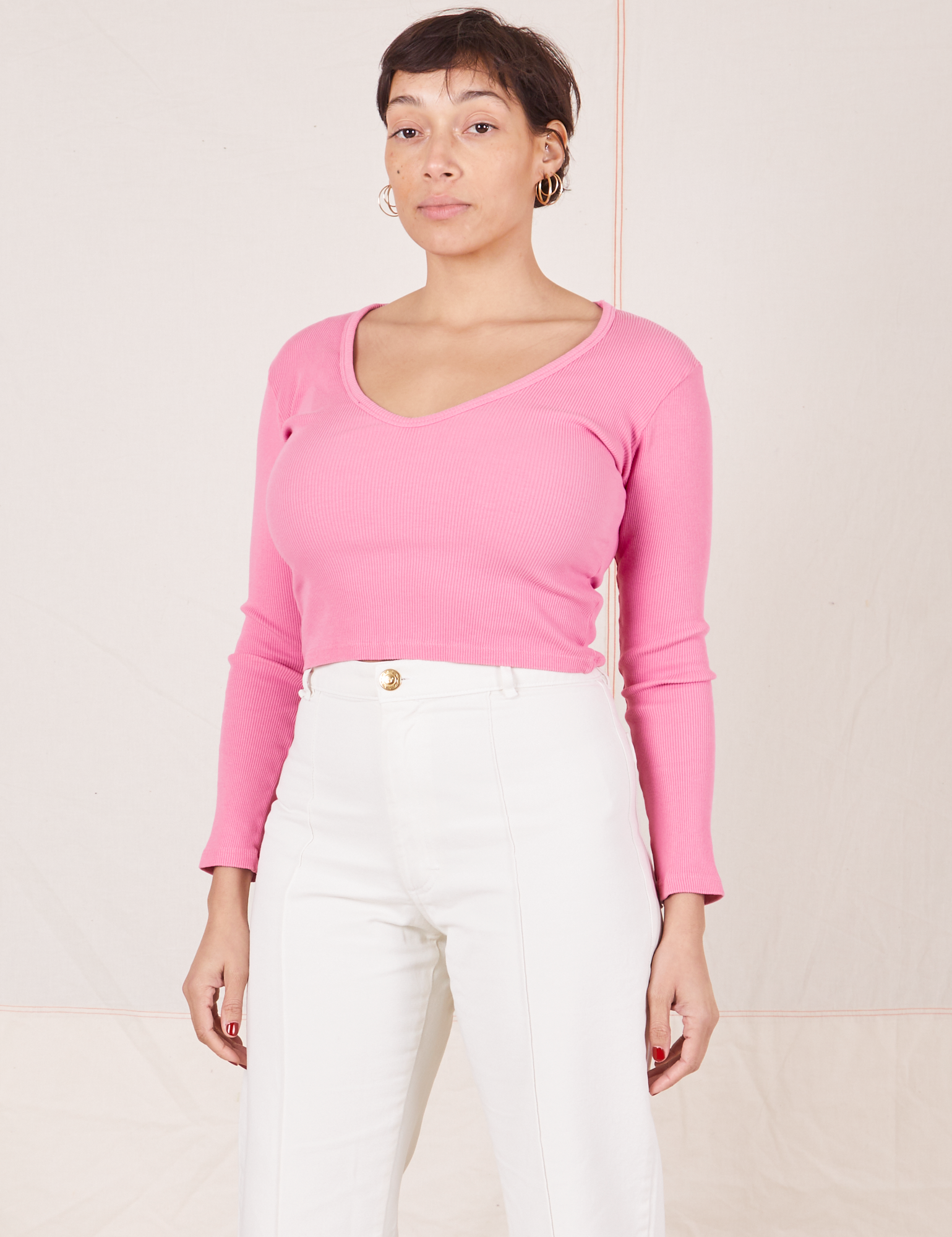 Tiara is wearing size S Long Sleeve V-Neck Tee in Bubblegum Pink paired with vintage tee off-white Western Pants