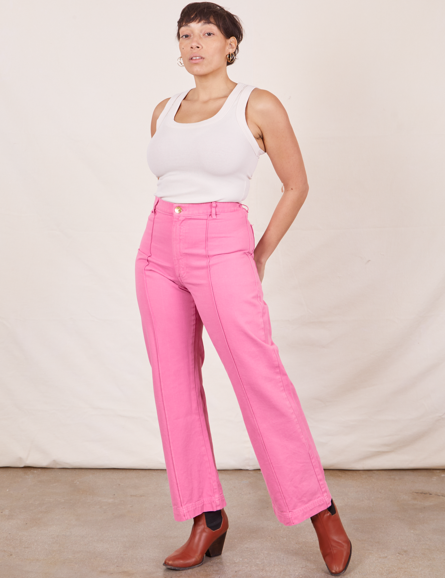 Tiara is 5&#39;4&quot; and wearing S Western Pants in Bubblegum Pink paired with Tank Top in vintage tee off-white