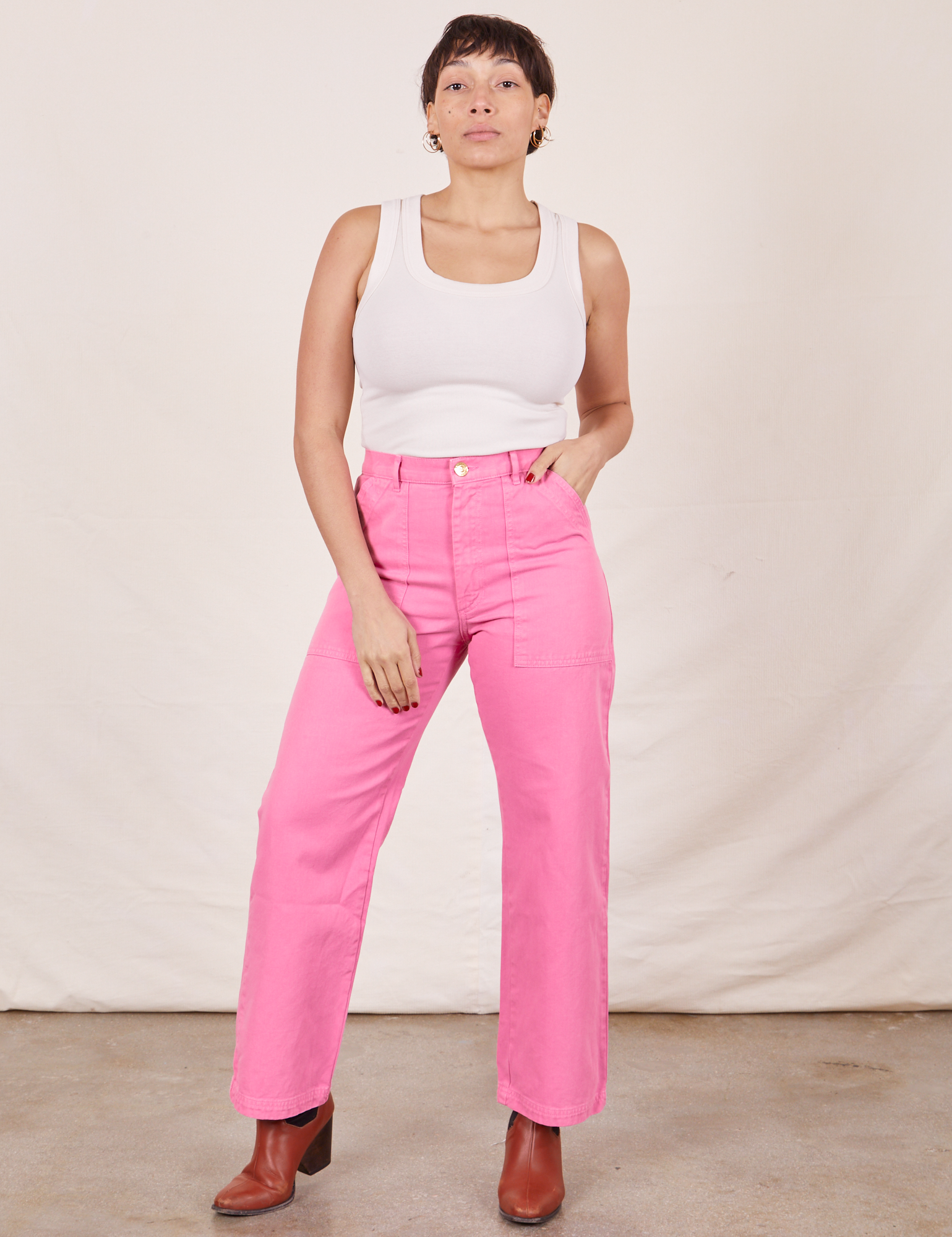 Tiara is 5&#39;4&quot; and wearing size S Work Pants in Bubblegum Pink paired with Tank Top in vintage tee off-white