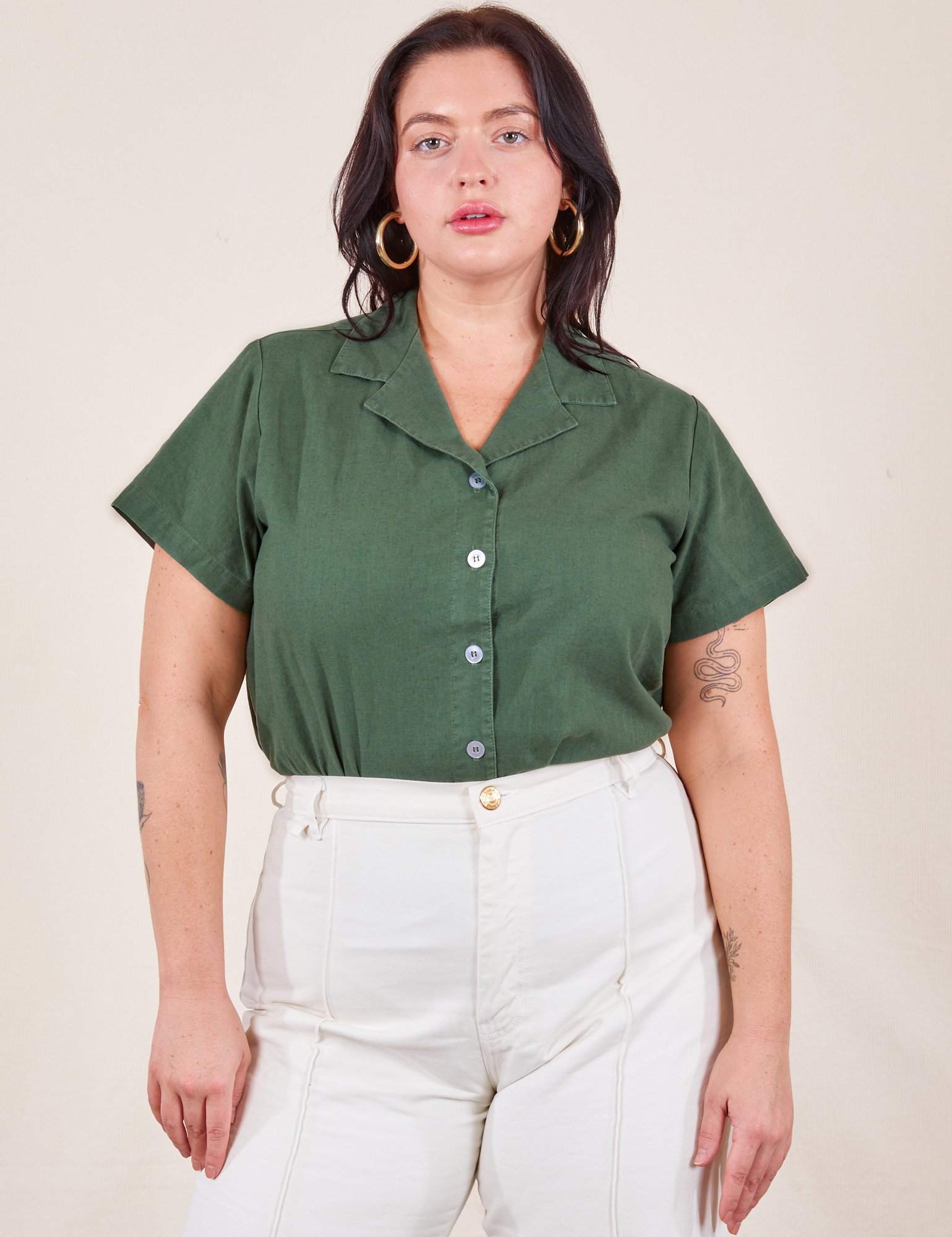 Faye is wearing M Pantry Button-Up in Dark Emerald Green tucked into vintage tee off-white Western Pants