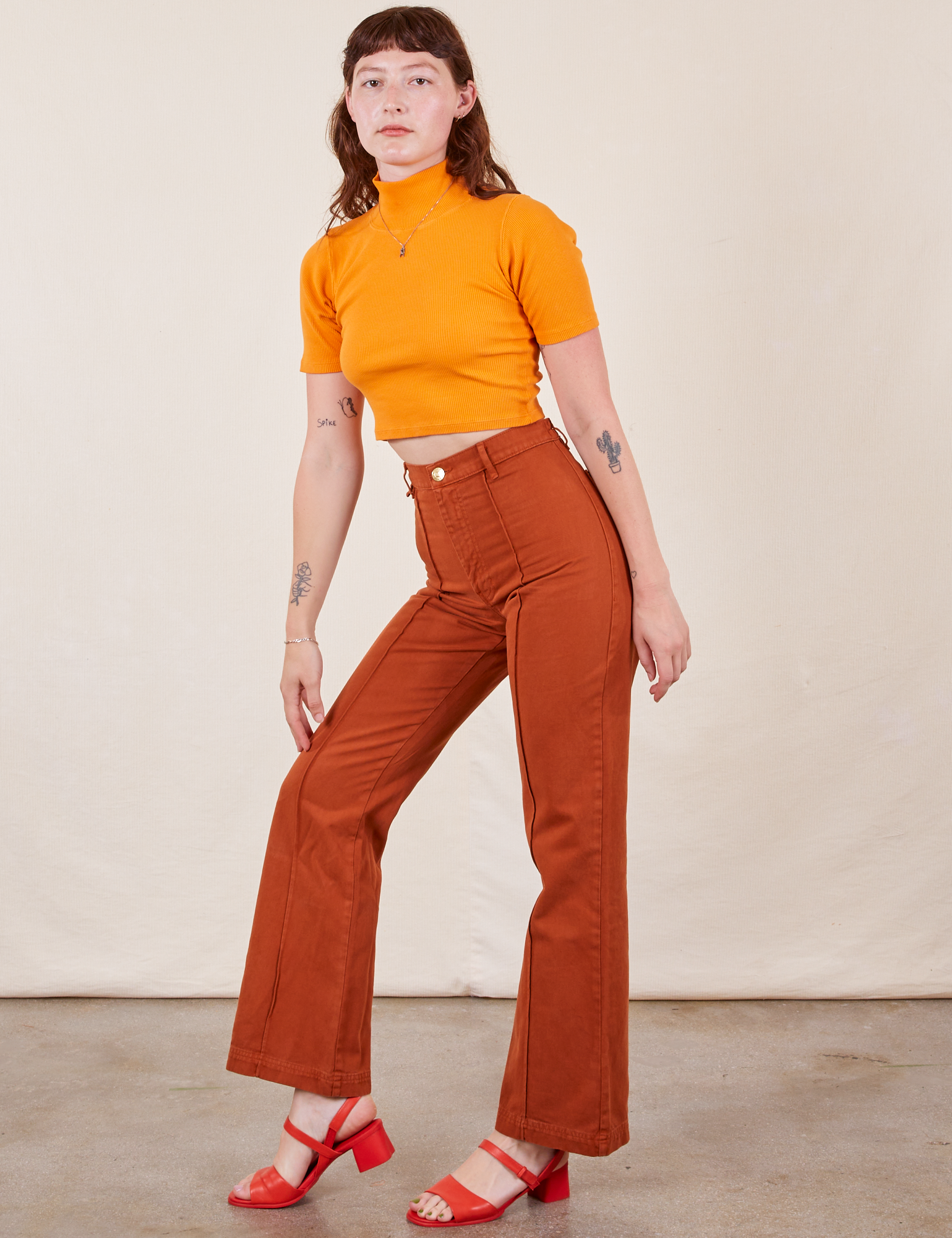 Alex is 5&#39;8&quot; and wearing XS Western Pants in Burnt Terracotta