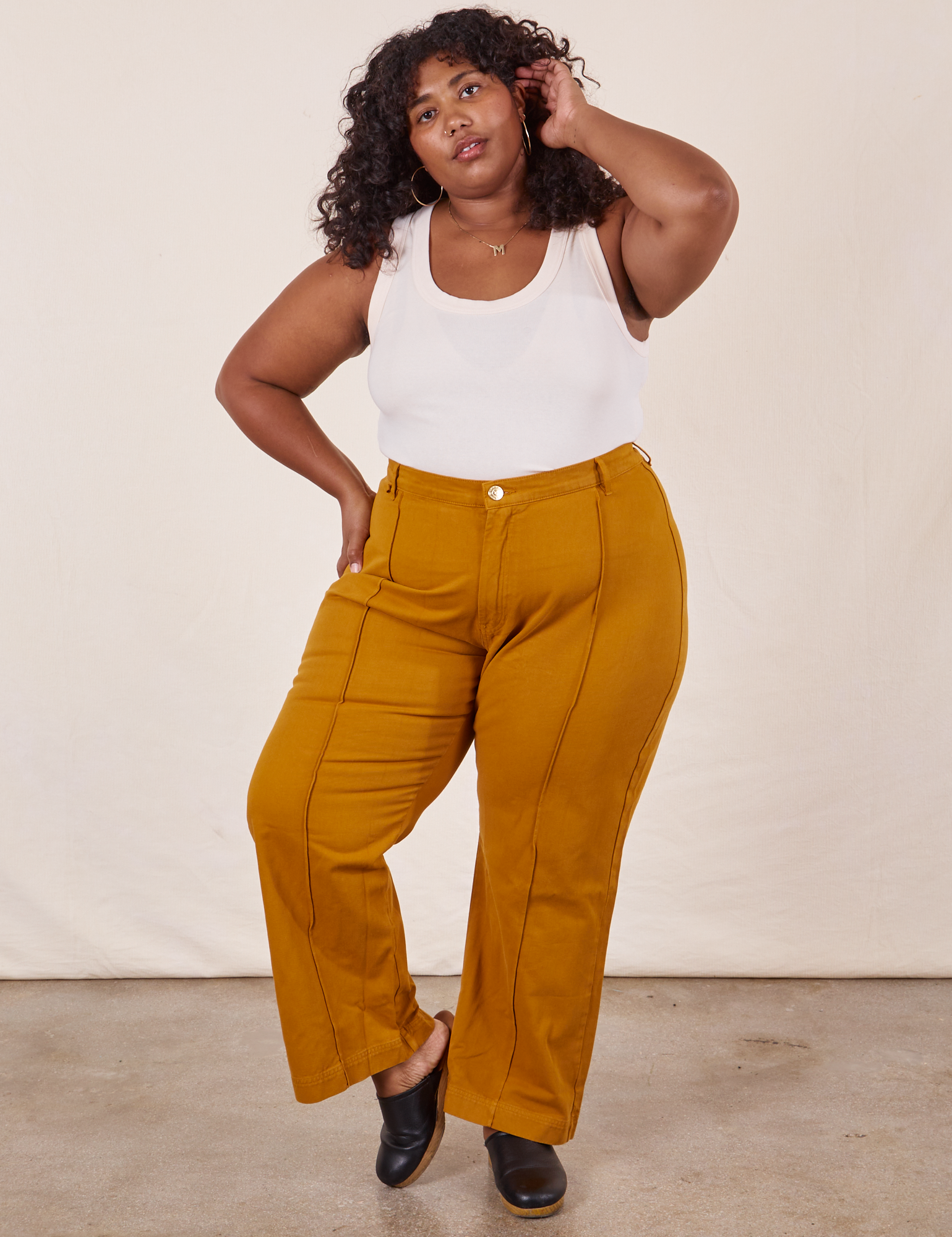 Morgan is 5&#39;5&quot; and wearing 1XL Western Pants in Spicy Mustard paired with vintage off-white Tank Top