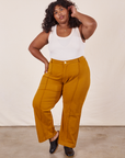 Morgan is 5'5" and wearing 1XL Western Pants in Spicy Mustard paired with vintage off-white Tank Top
