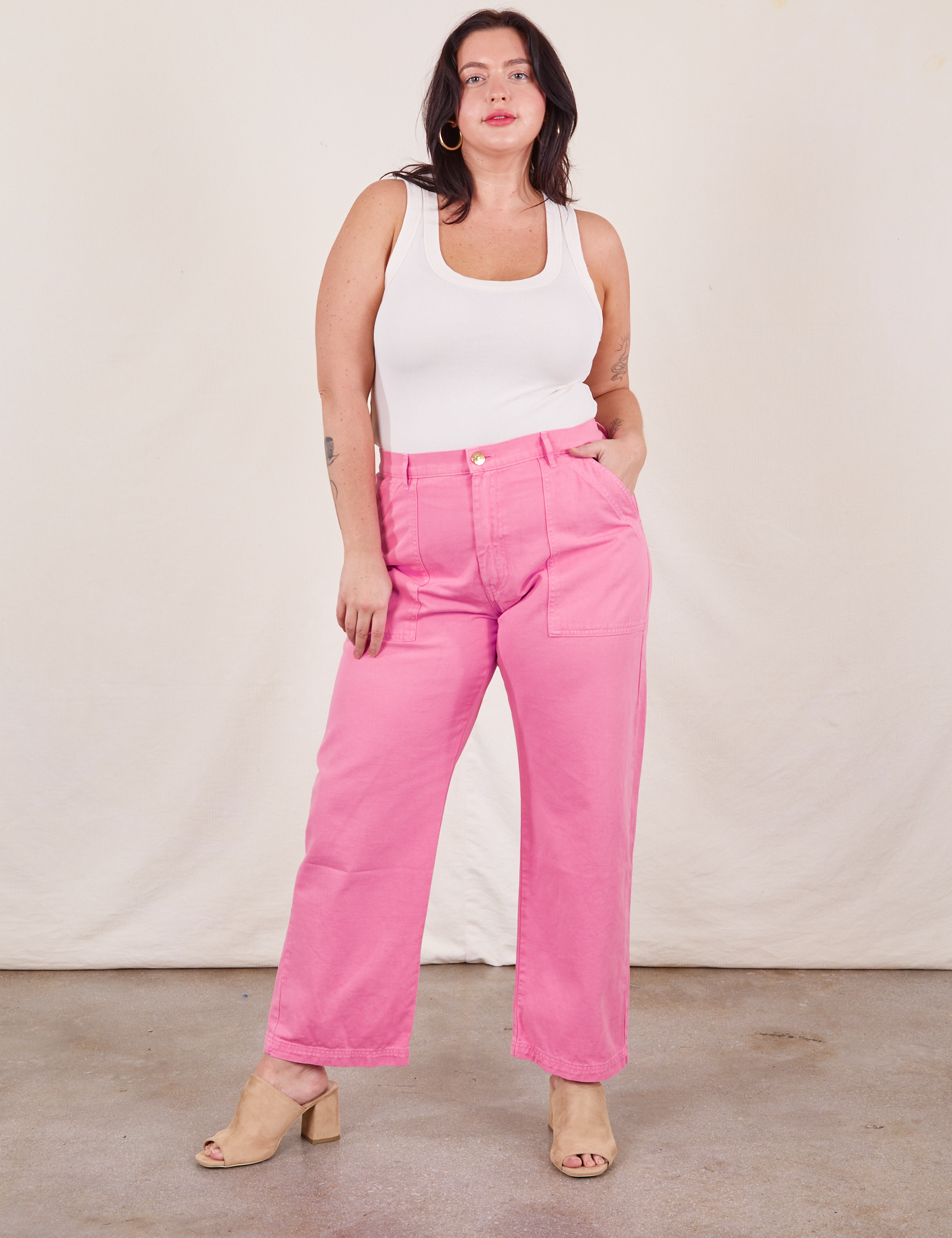 Faye is 5&#39;7&quot; and wearing L Work Pants in Bubblegum Pink paired with a vintage off-white Tank Top