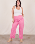 Faye is 5'7" and wearing L Work Pants in Bubblegum Pink paired with a Tank Top in vintage tee off-white