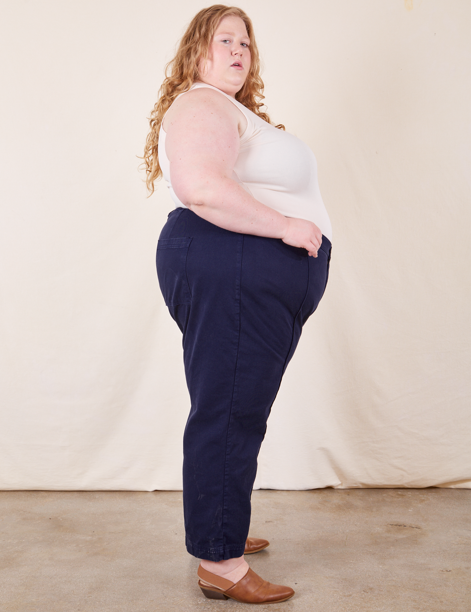 Side view of Western Pants in Navy Blue and vintage off-white Tank Top on Catie