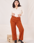 Melanie is 5'6" and wearing M Organic Work Pants in Burnt Terracotta paired with vintage off-white Long Sleeve Fisherman Polo